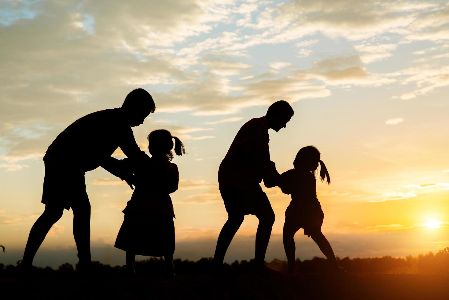 Sunset silhouette of children playing photo