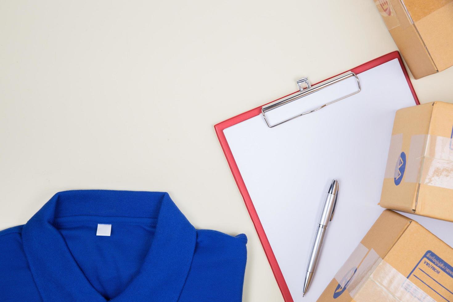 Top view of worker's shirt and postage boxes photo