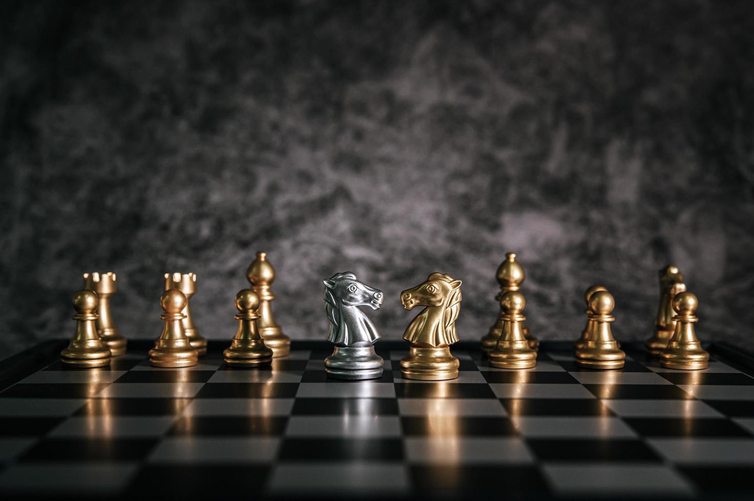 Gold and silver chess board pieces photo