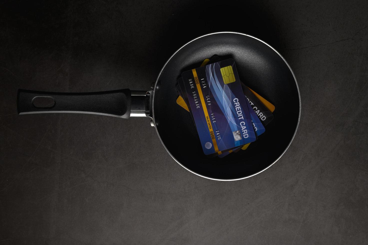 Credit cards in a pan on a black background photo