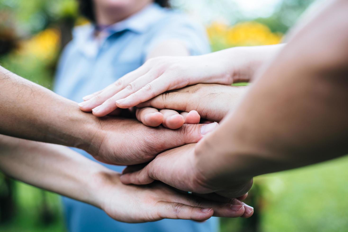 Close-up of a team of students with their hands together photo