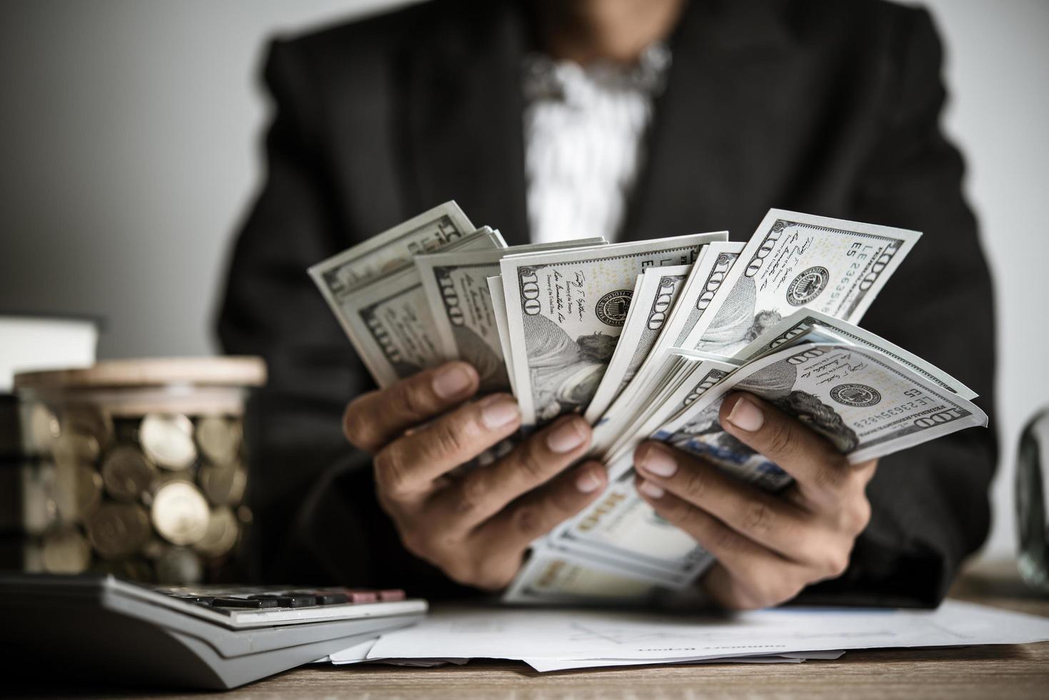 Hands of businesswoman holding money photo