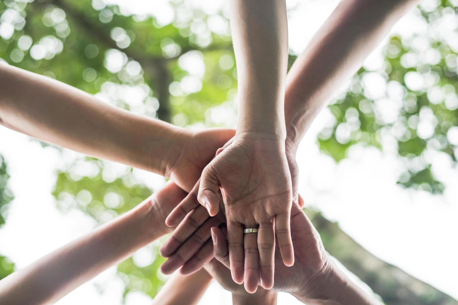 Close-up of a team of students with their hands together photo