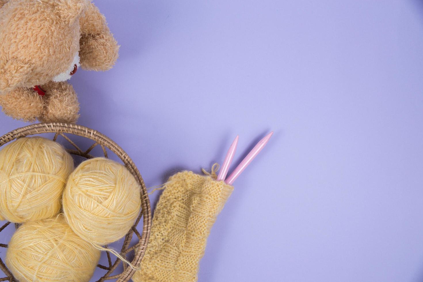 Top view of sewing material on purple background photo