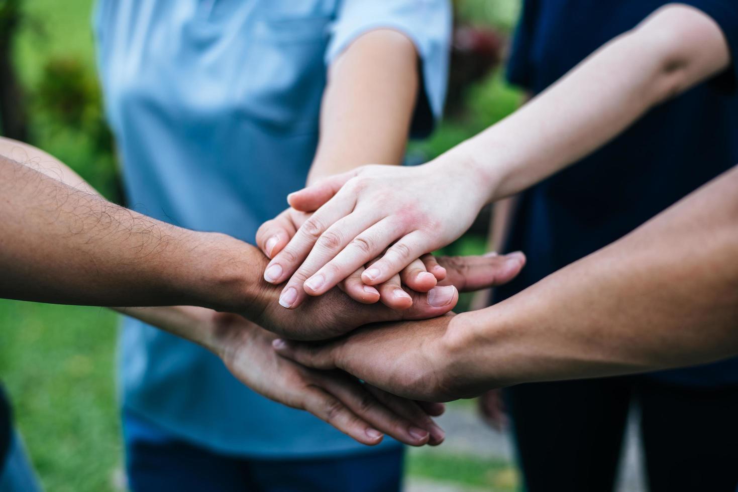 Close-up of a team of students with their hands together photo