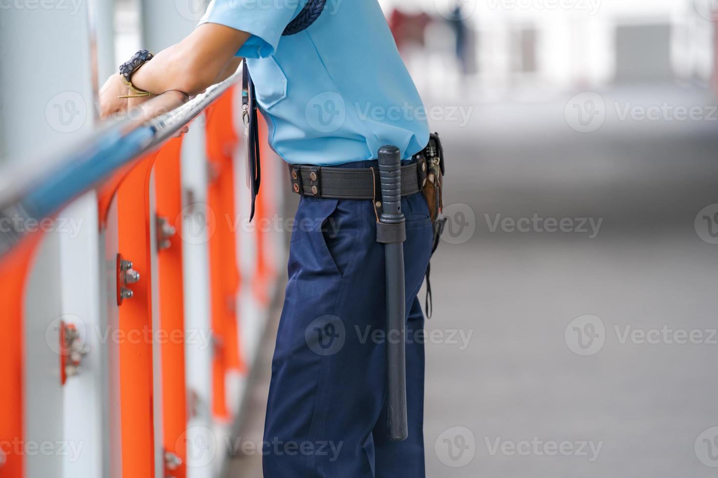 Security guard leaning on railing photo