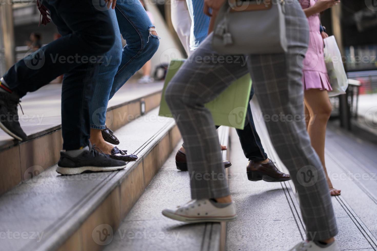 Close-up of people's feet walking on stairs photo