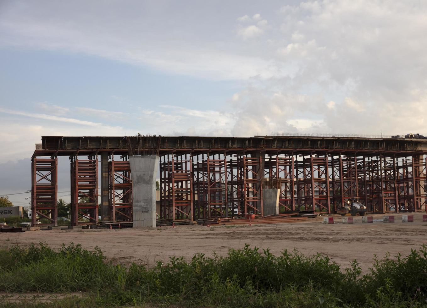 Construction concrete bridge across an intersection to solve traffic issues photo
