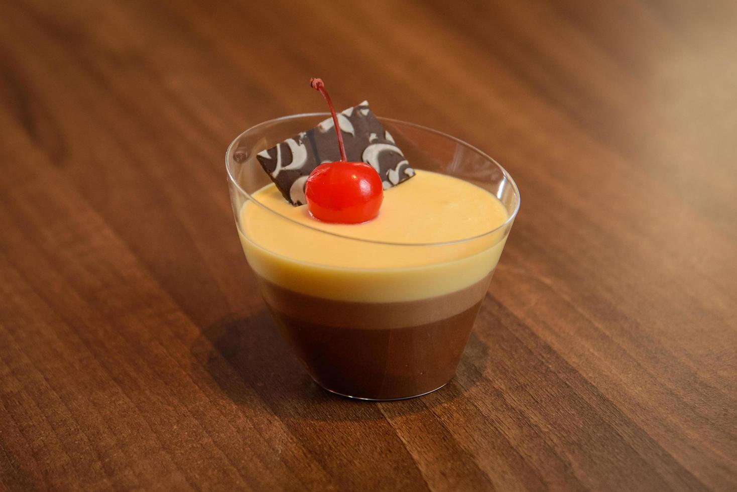 Layered chocolate desserts with decoration on wooden table photo