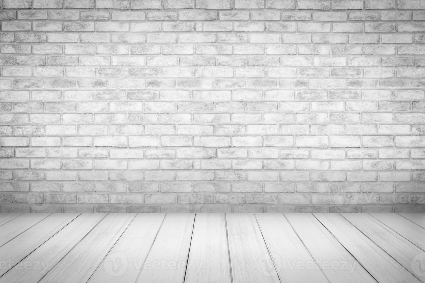 White wood floor with brick wall background photo