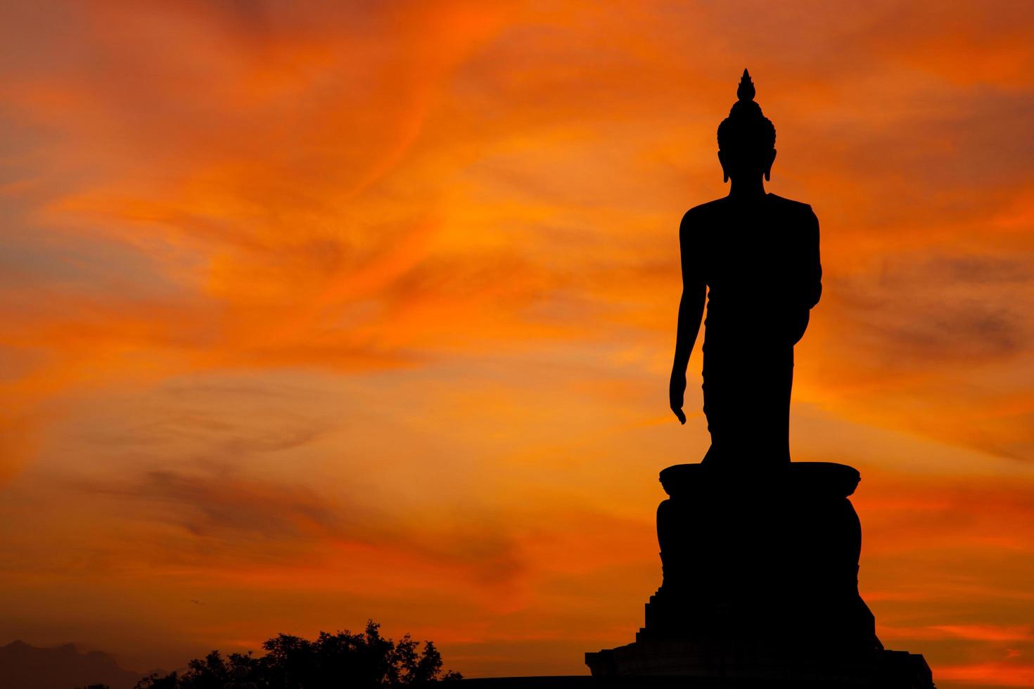 Buddha statue at sunset in Thailand photo