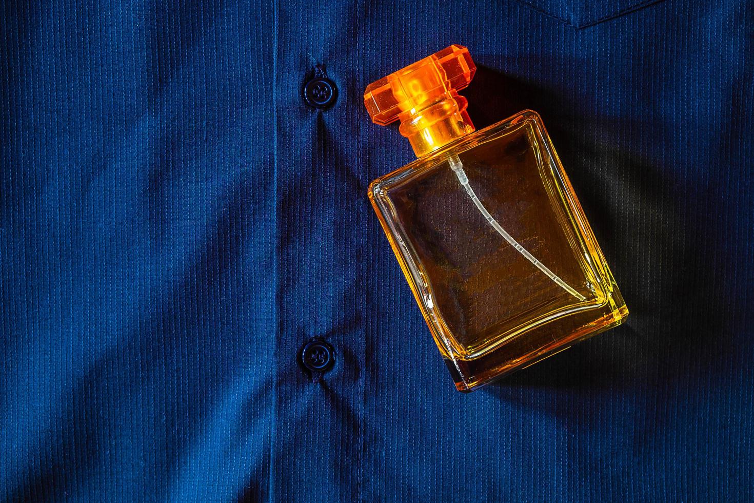 Perfume on blue cloth photo
