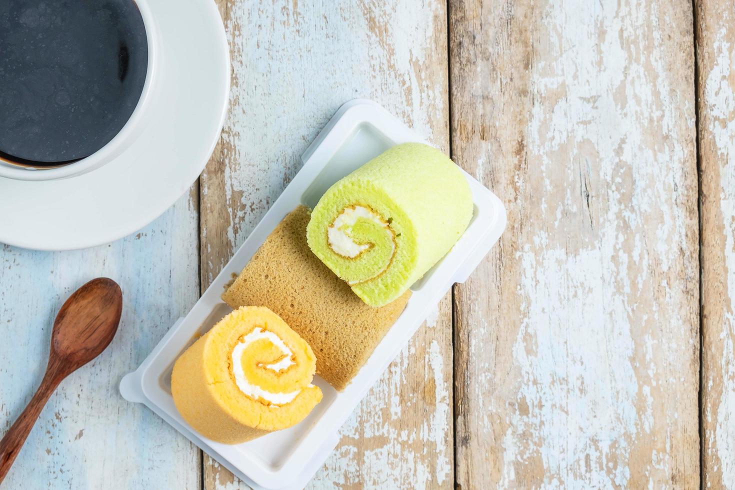 Cake rolls on a plate with coffee photo