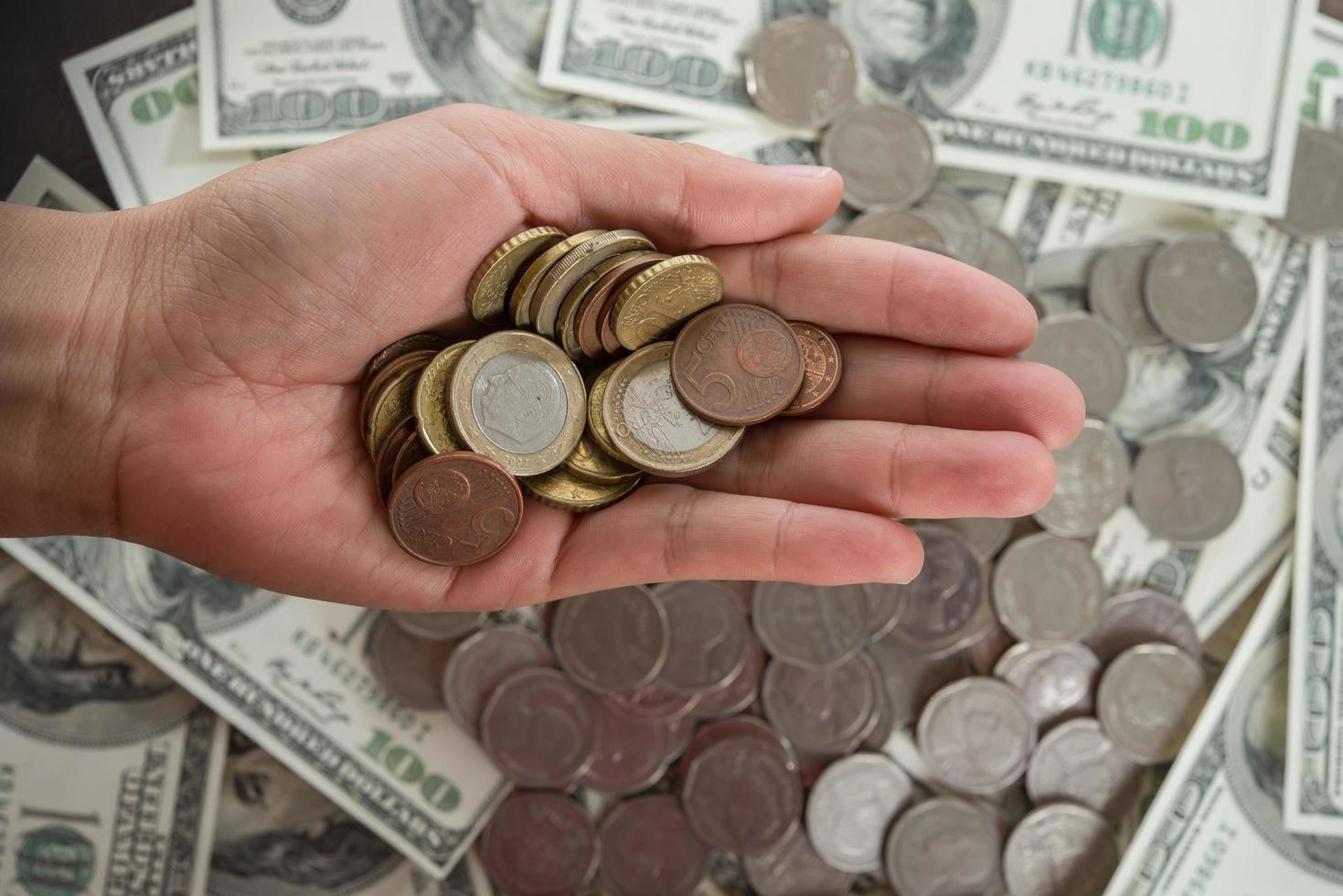 Coins in hand on dollar bank background photo