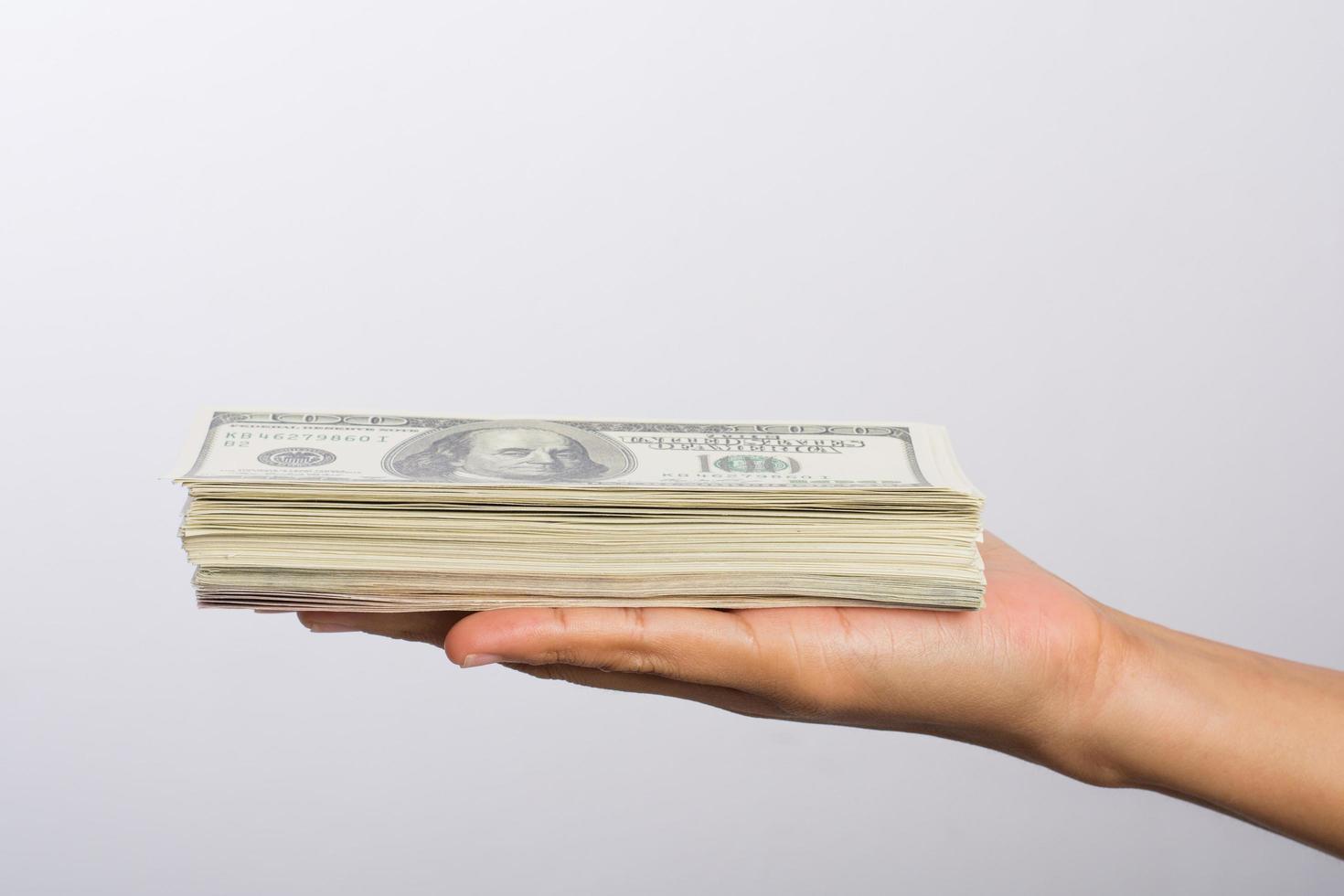 Woman's hand with money isolated on white background photo