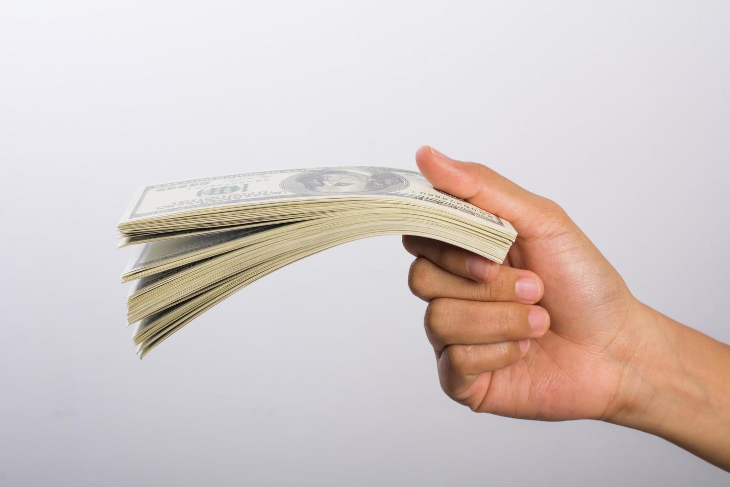 Woman's hand with money isolated on white background photo