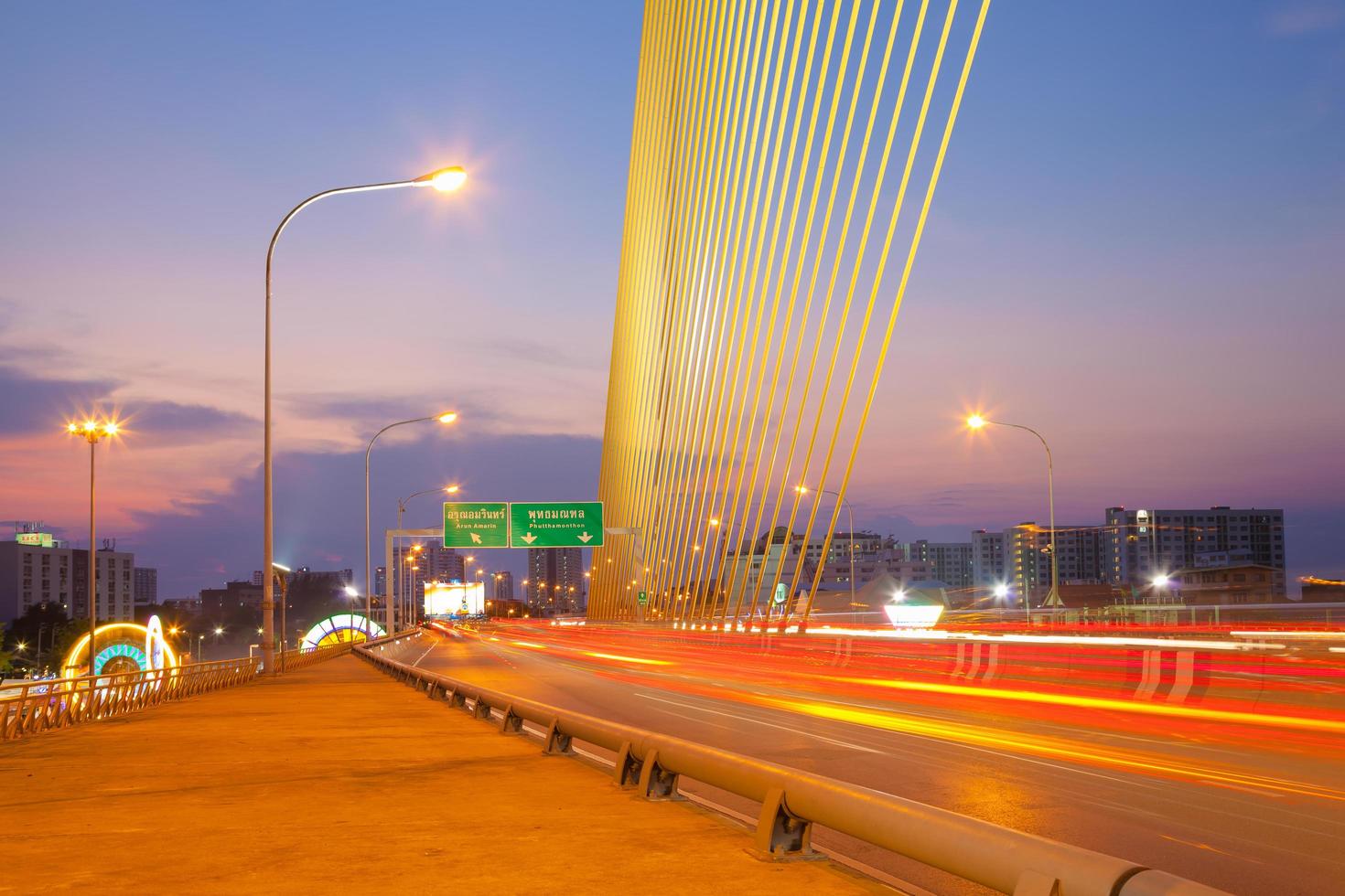 Traffic on the bridge in Bangkok at sunset photo