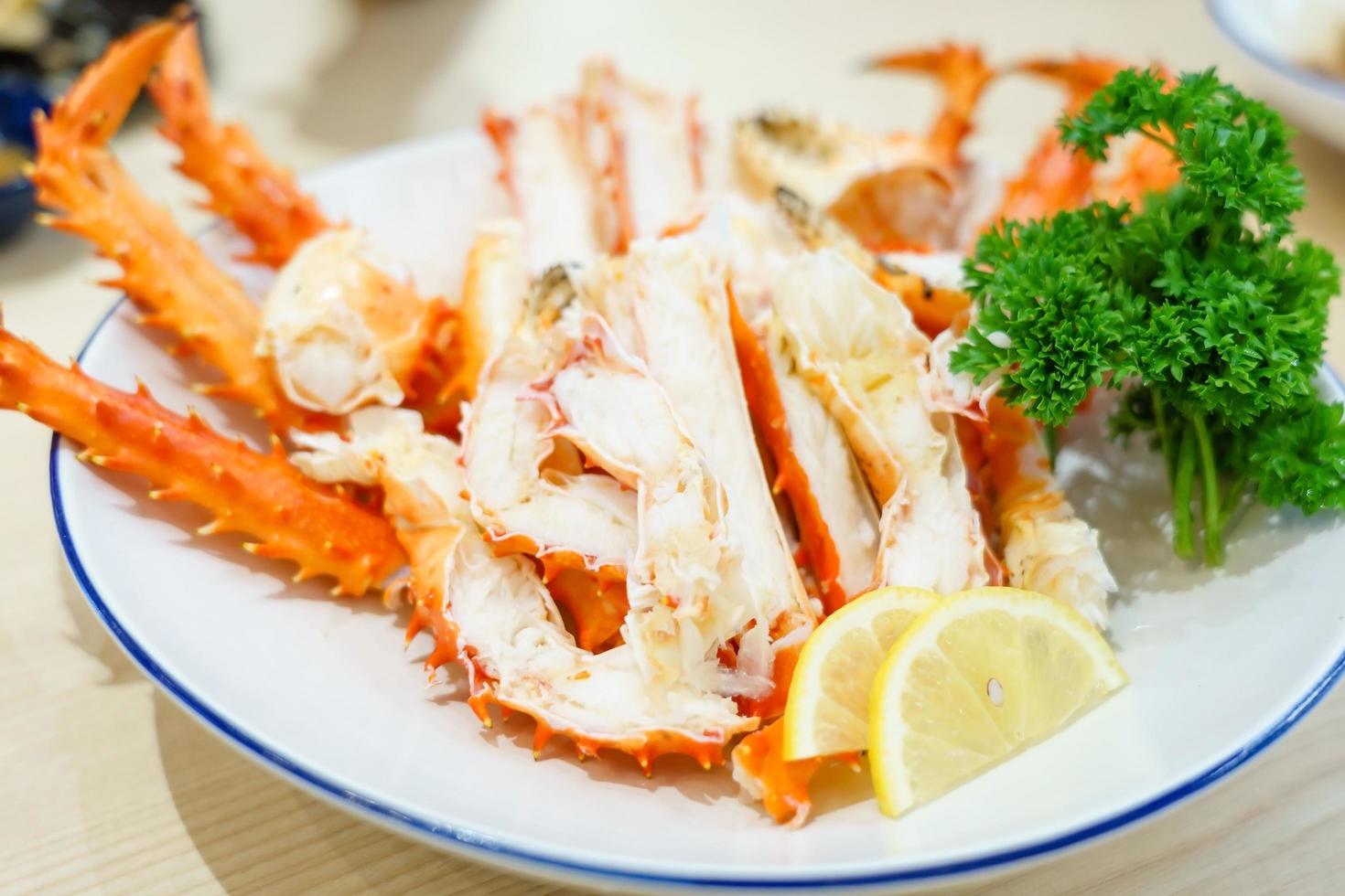 Red king crab legs with fresh lemon slices photo