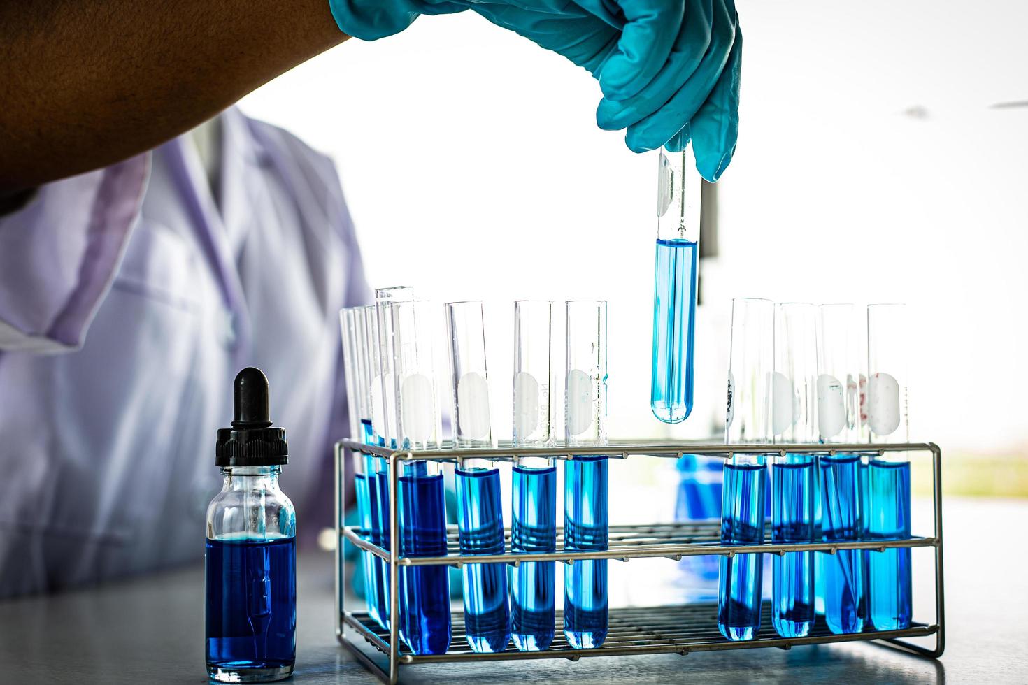 Scientific test tubes with blue liquid photo