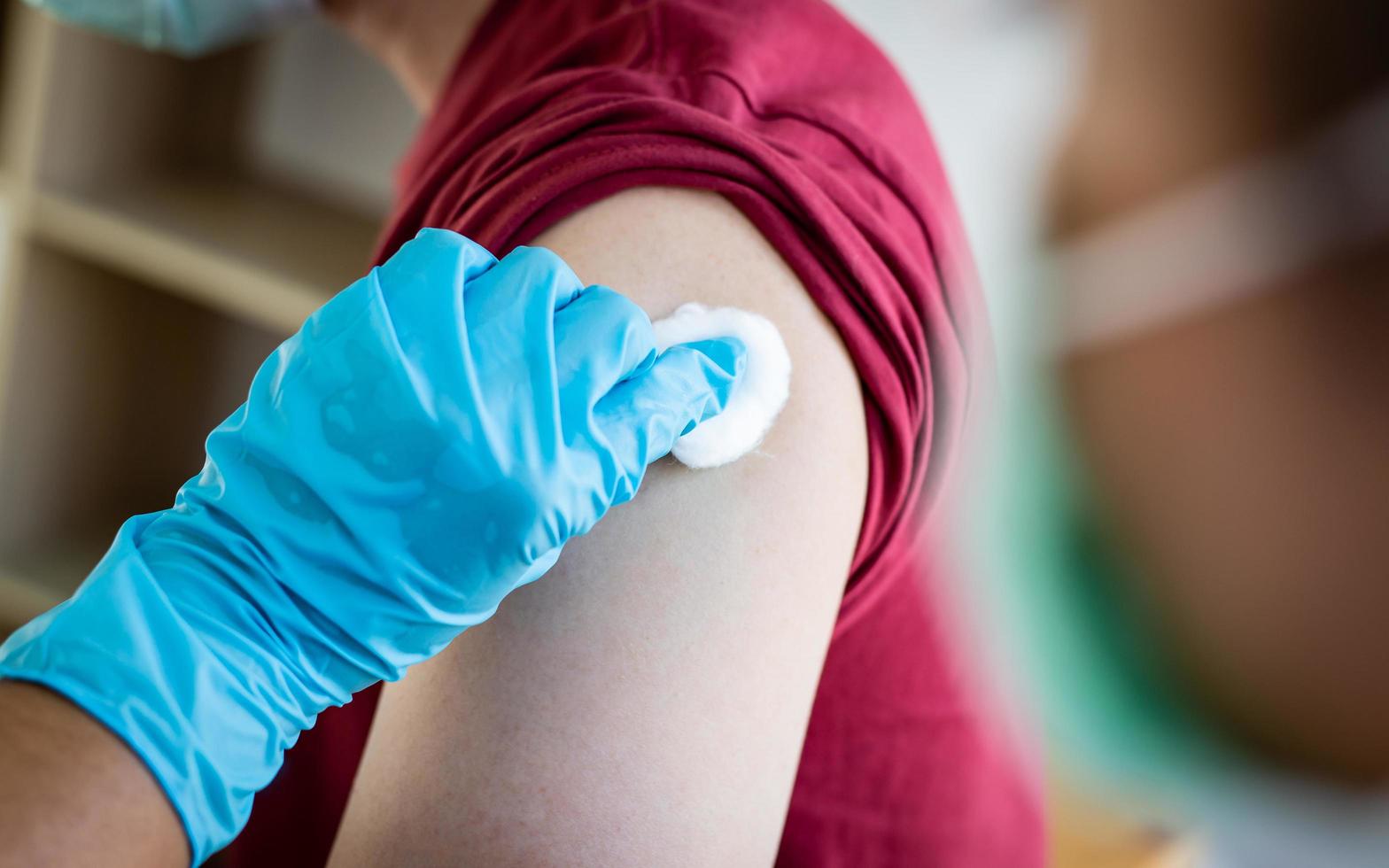 Doctor applying pressure to patient's shot wound photo