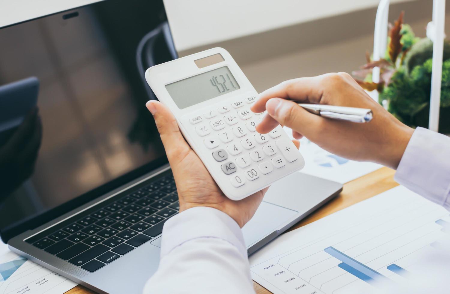 Scientist using a white calculator photo