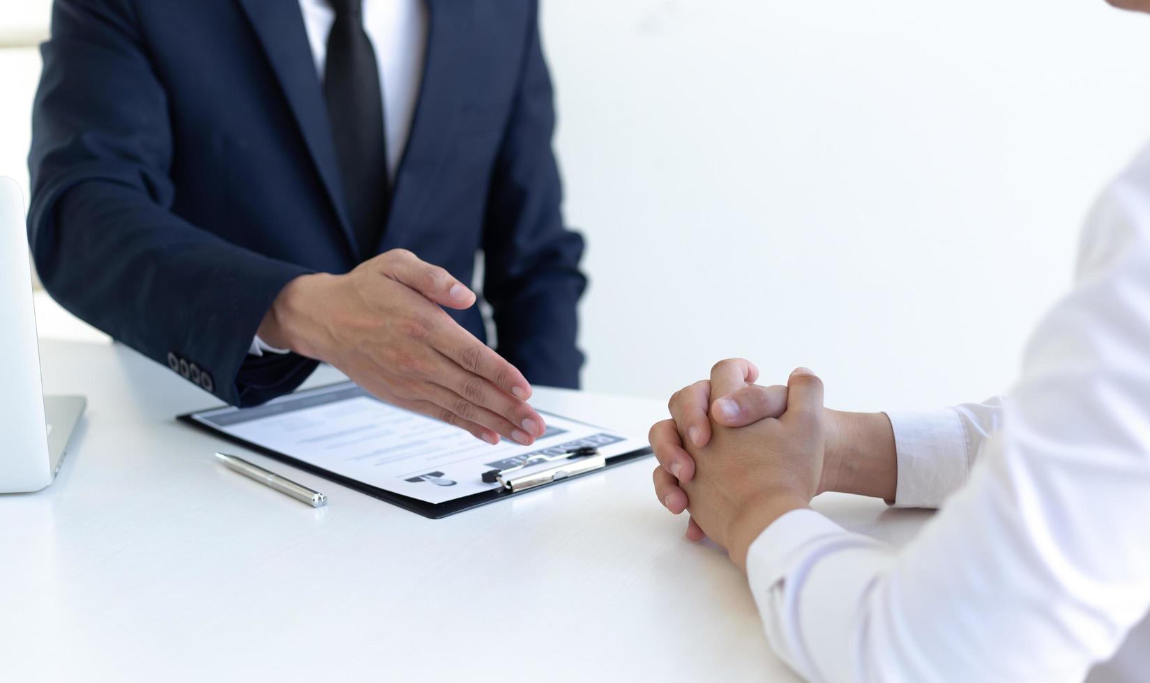 Shaking hands in a white room photo