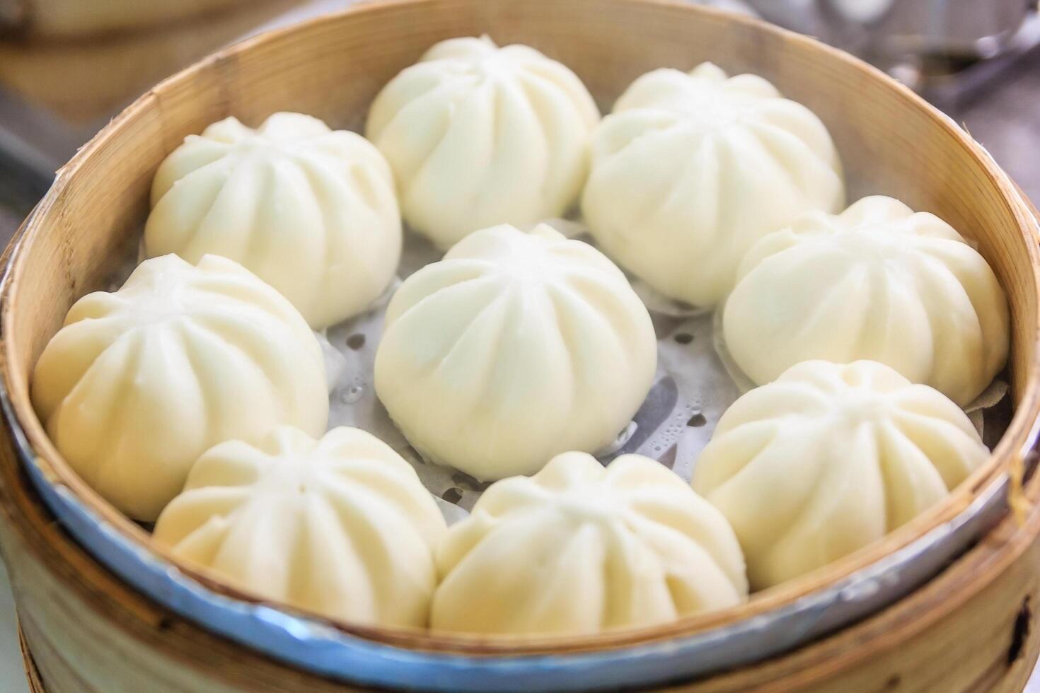 Steamed pork buns in bamboo basket photo