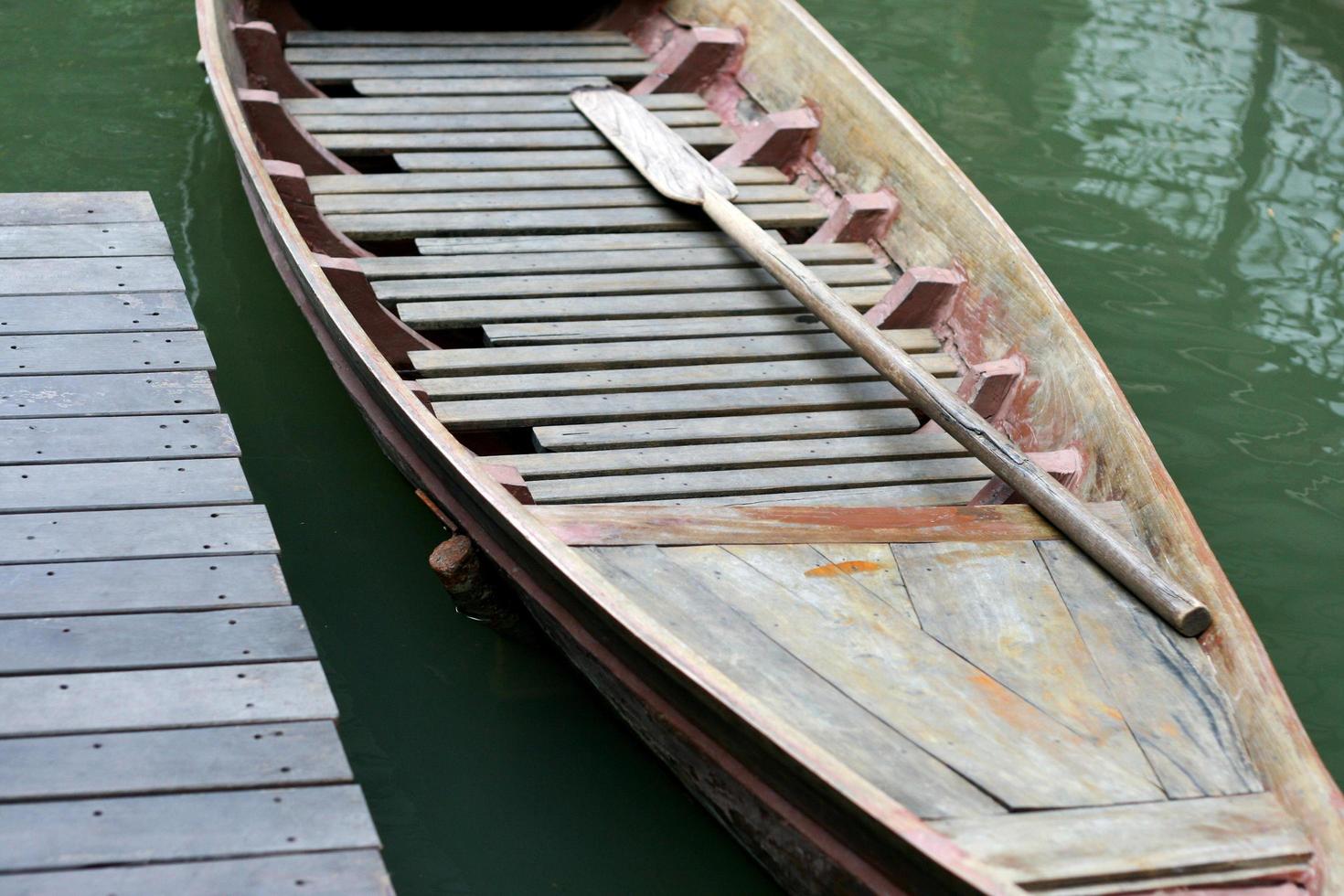 Wooden boat with paddles photo