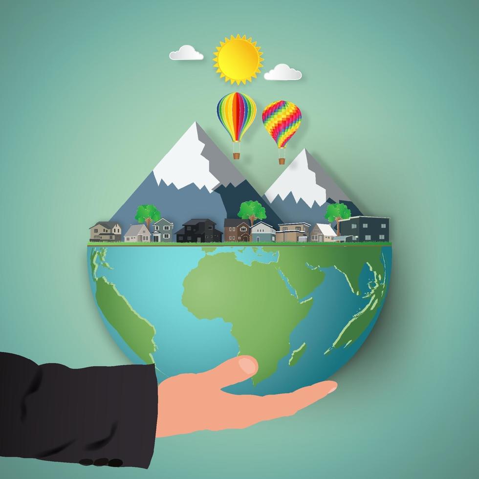 Businessman's hand holding earth with mountains and houses vector