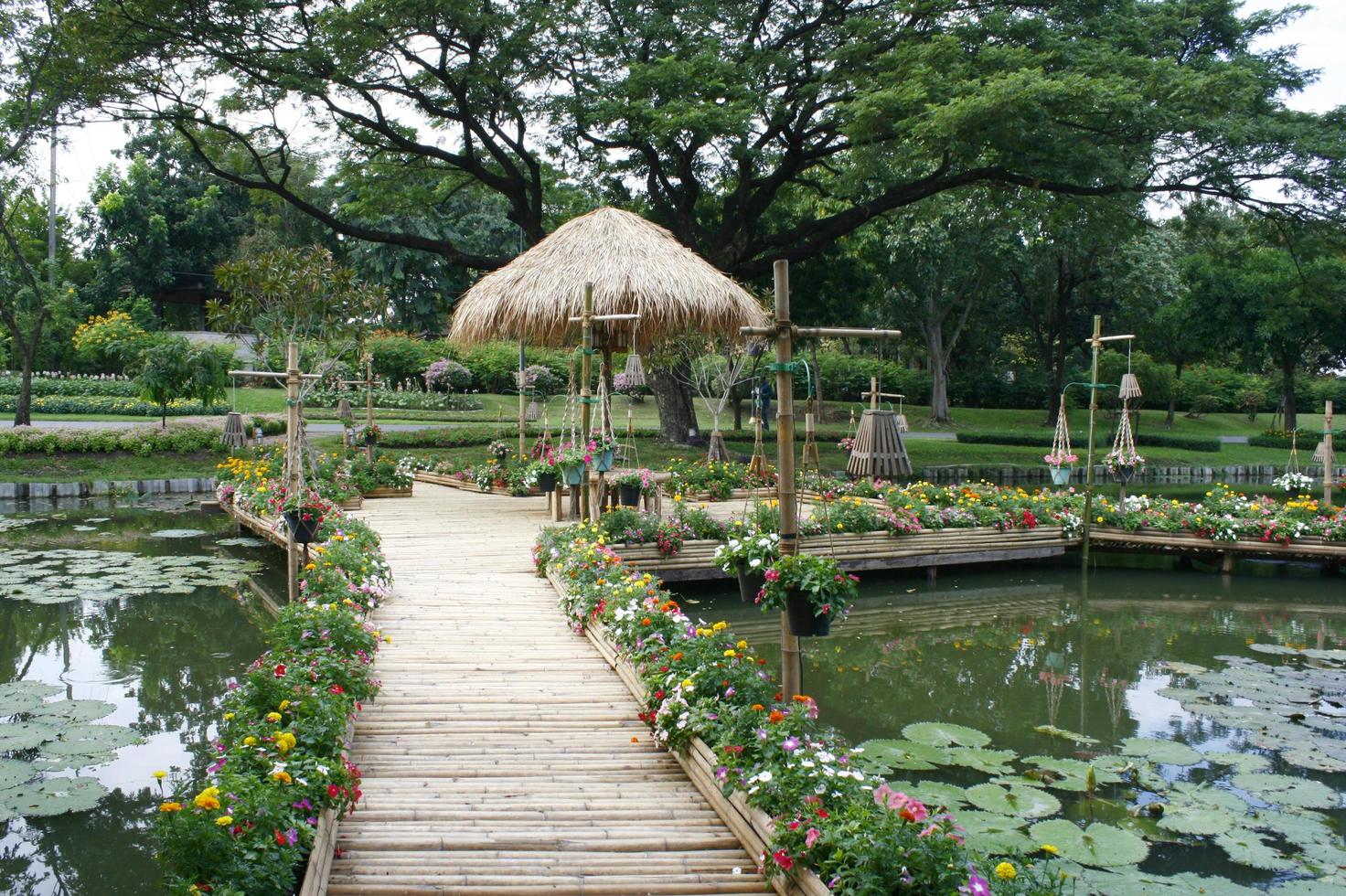 puente con una cabaña y flores en él foto