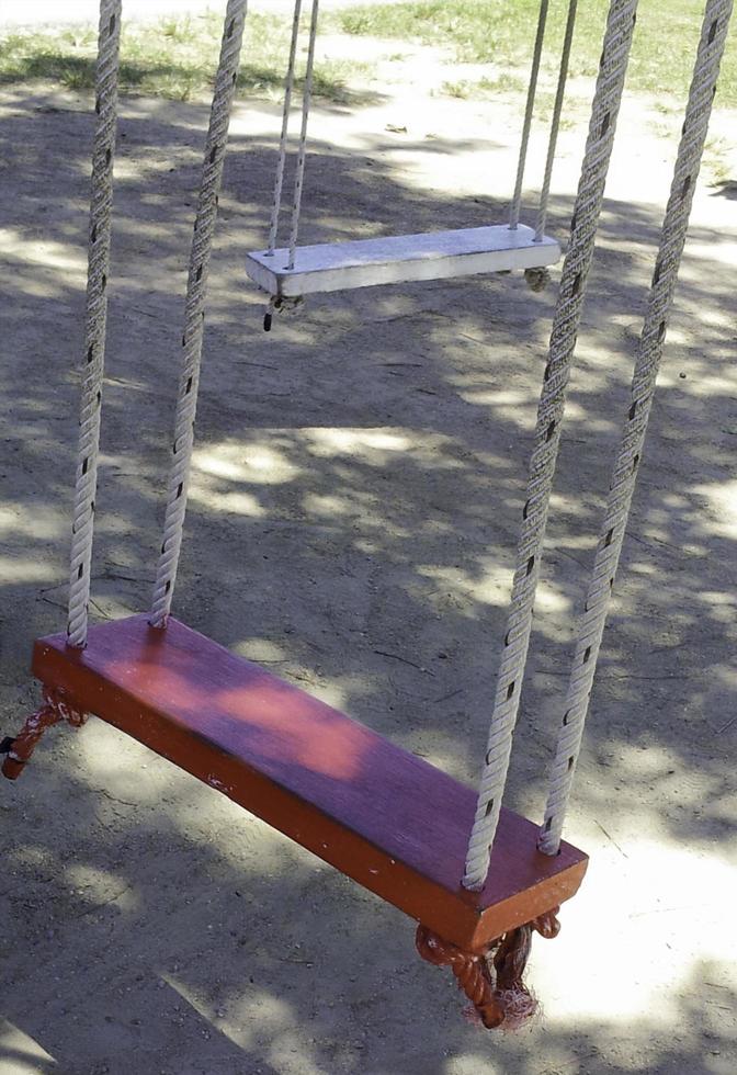 Wooden swings outside photo