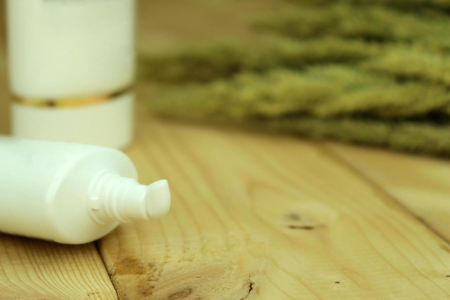 Close-up of a white cream tube on wood photo