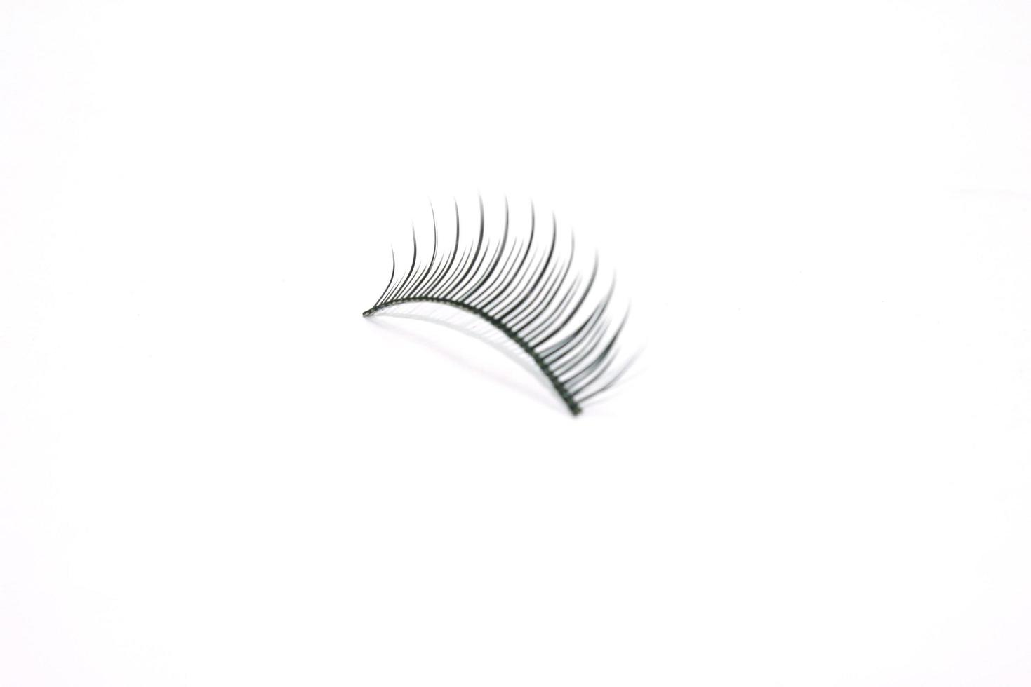 Single eyelash on white photo