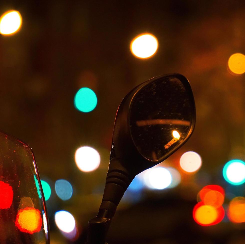 Rear view mirror with bokeh street lights photo