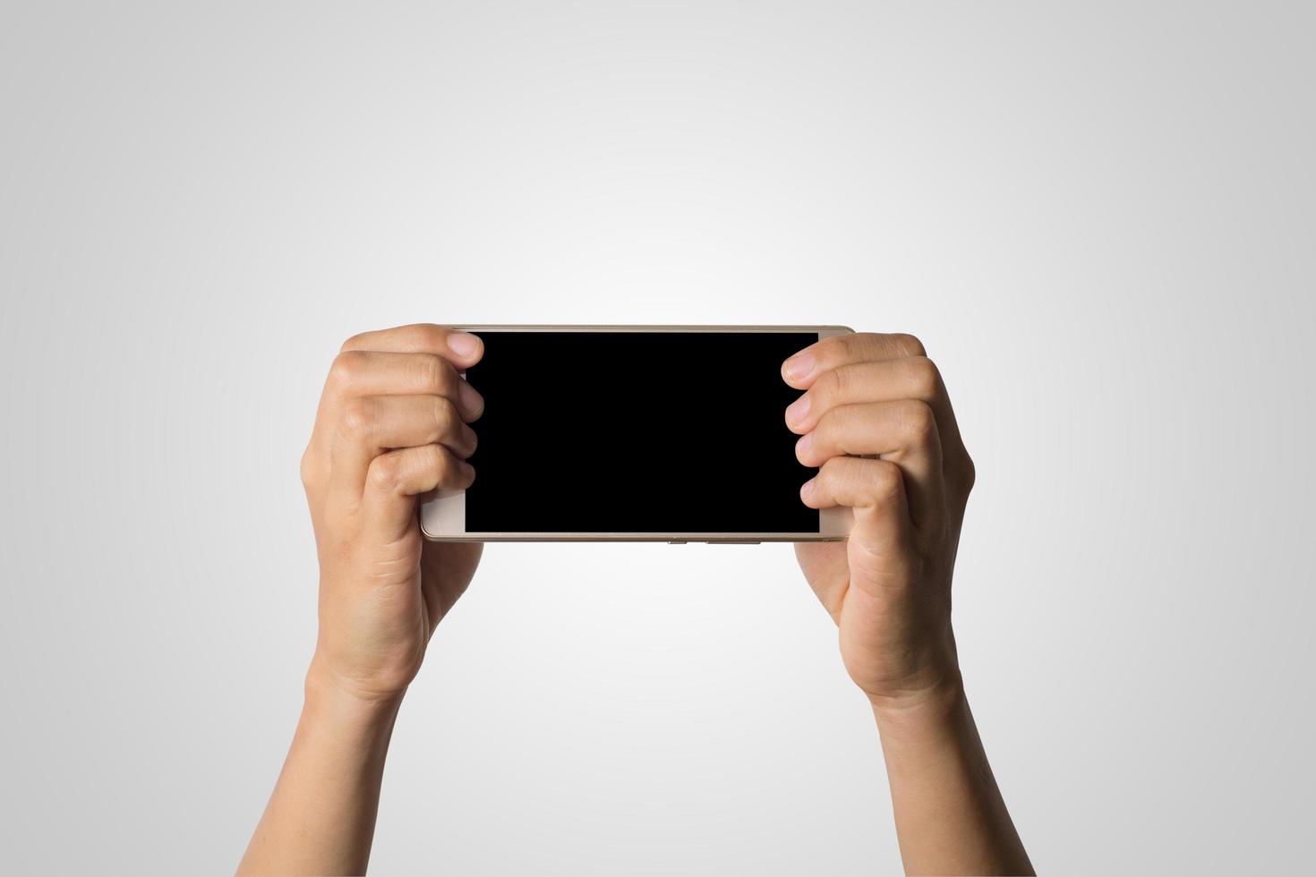 Hand holding a smartphone with blank screen photo