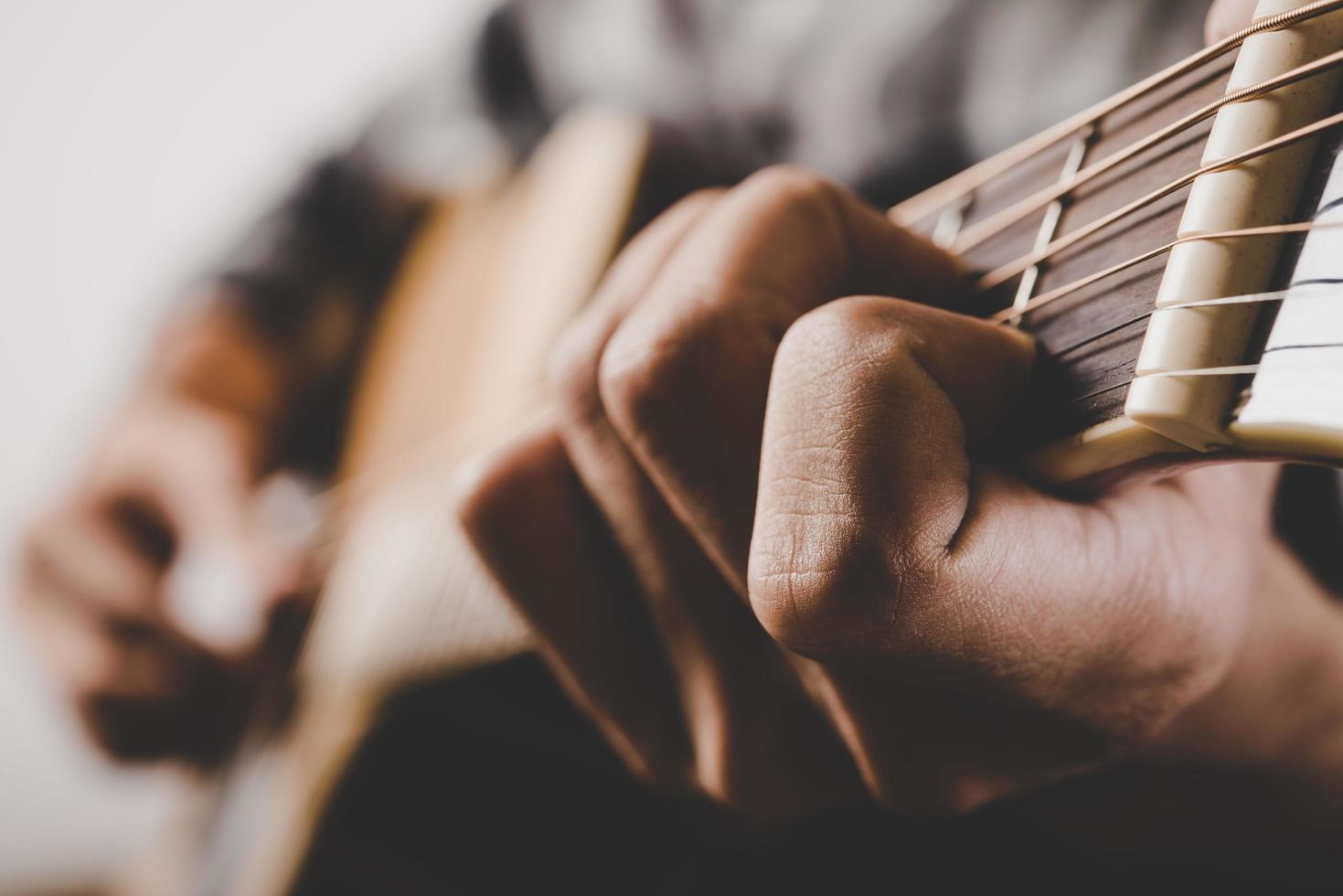 Close-up of man playing guitar photo