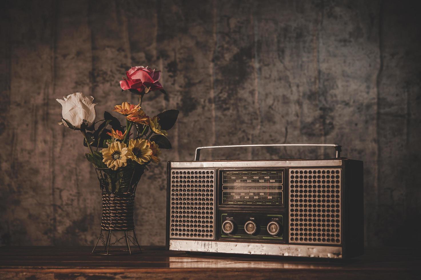 Still life with a retro radio receiver and flower vases photo