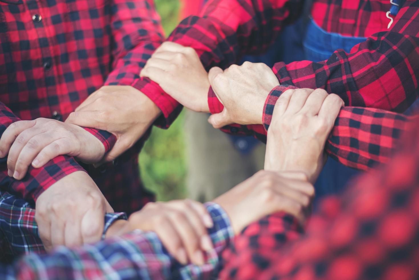 Close-up view of young people putting their hands together photo