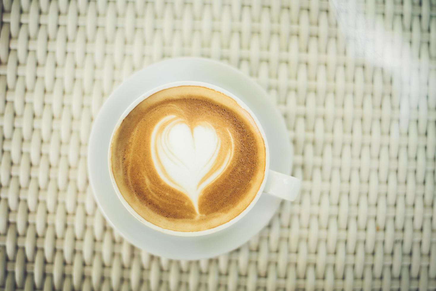 Latte art coffee with heart-shaped milk foam photo