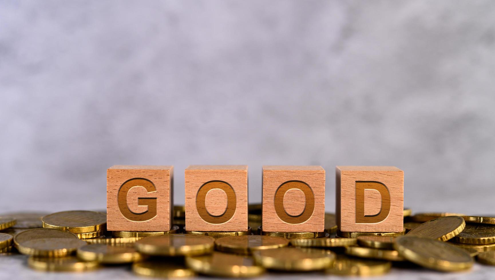 Letras de cubo de madera del alfabeto colocadas en monedas de oro foto