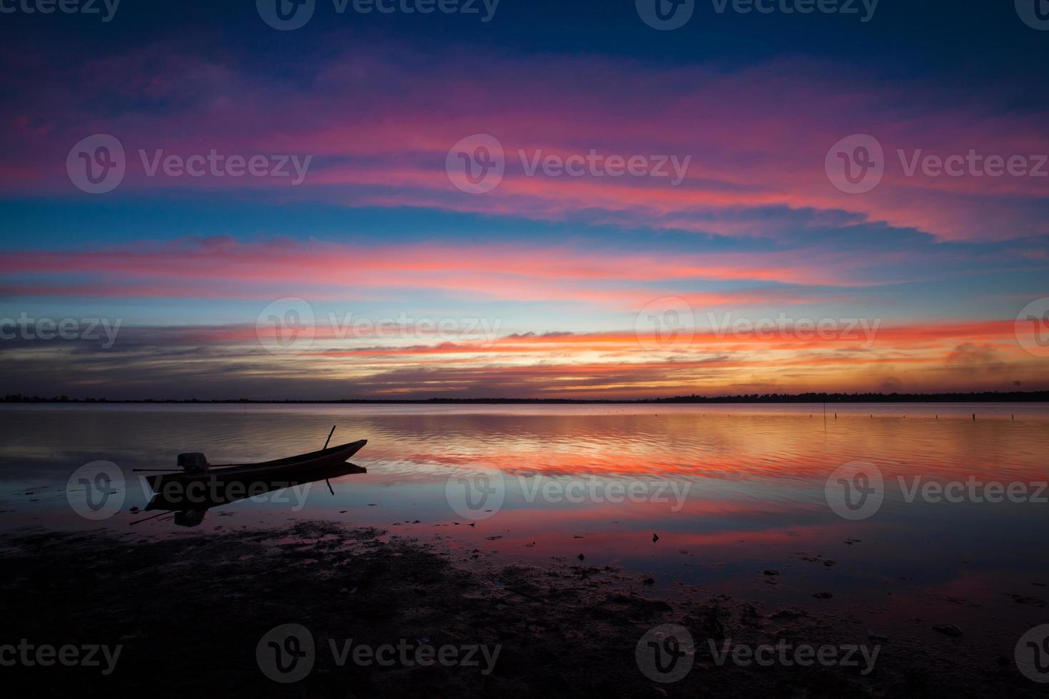 Silhouette of a boat at sunset photo