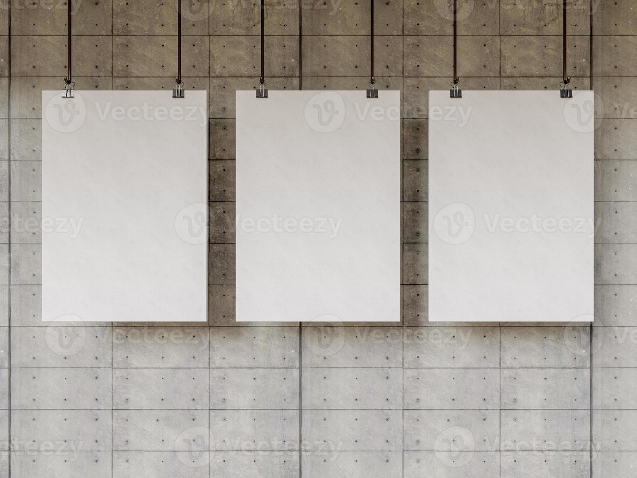 Three blank posters hang on old cement wall photo