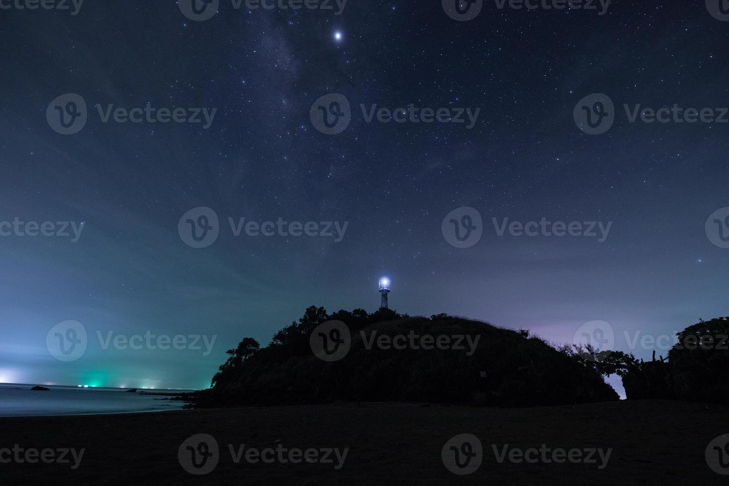 Starry sky and a lighthouse photo