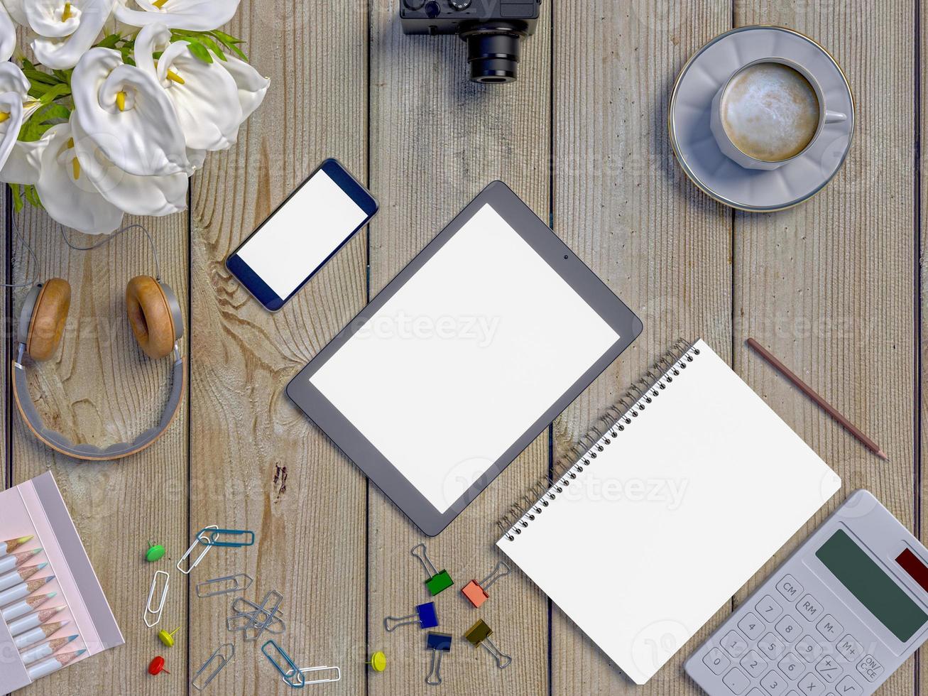 simulacro de espacio de trabajo en la mesa con portátil, tableta, teléfono, auriculares foto