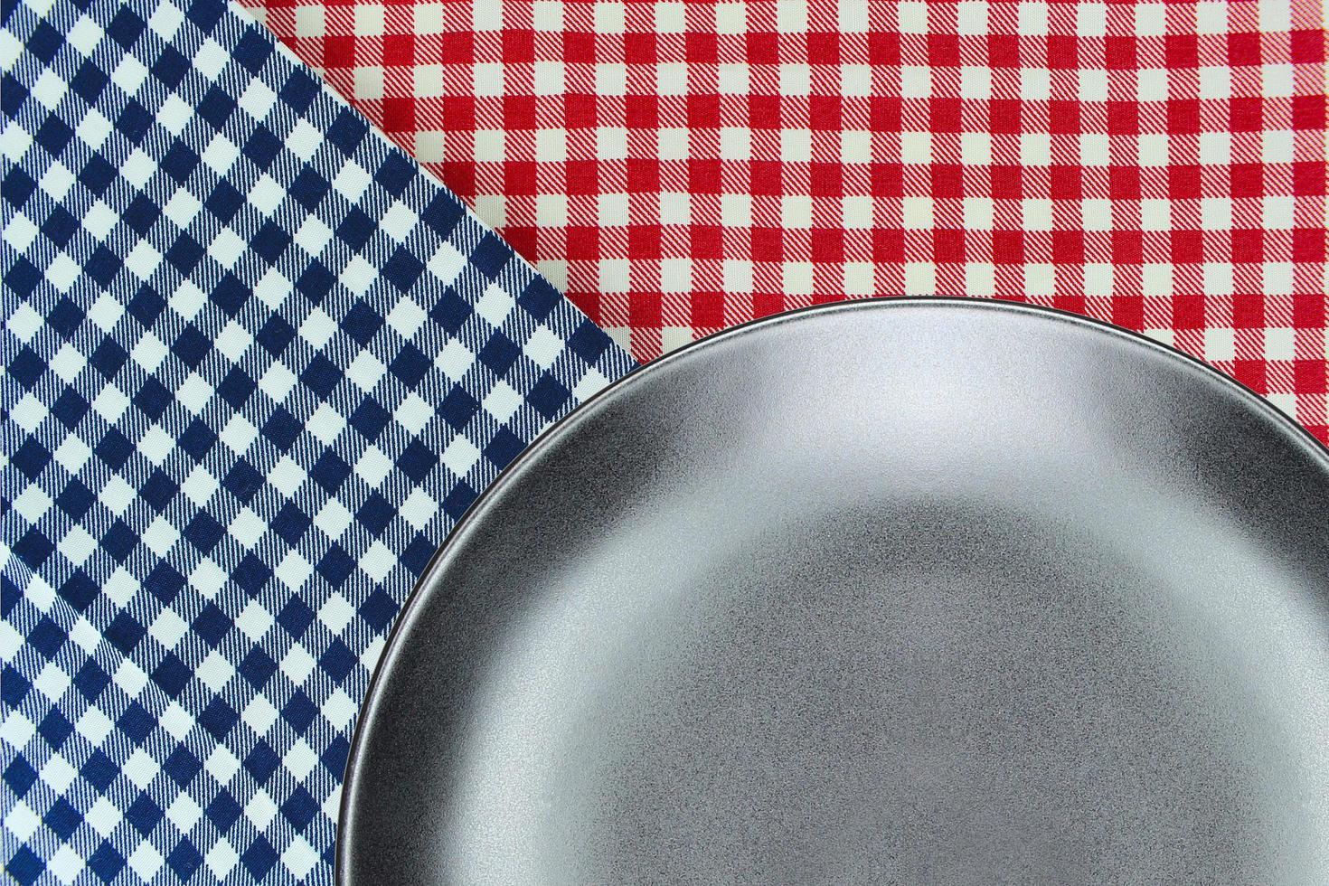 Black plate on red and blue cloth photo