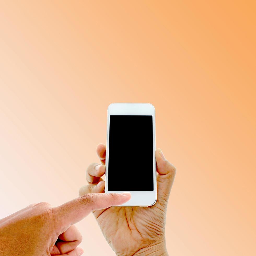 Person using a phone on an orange background photo