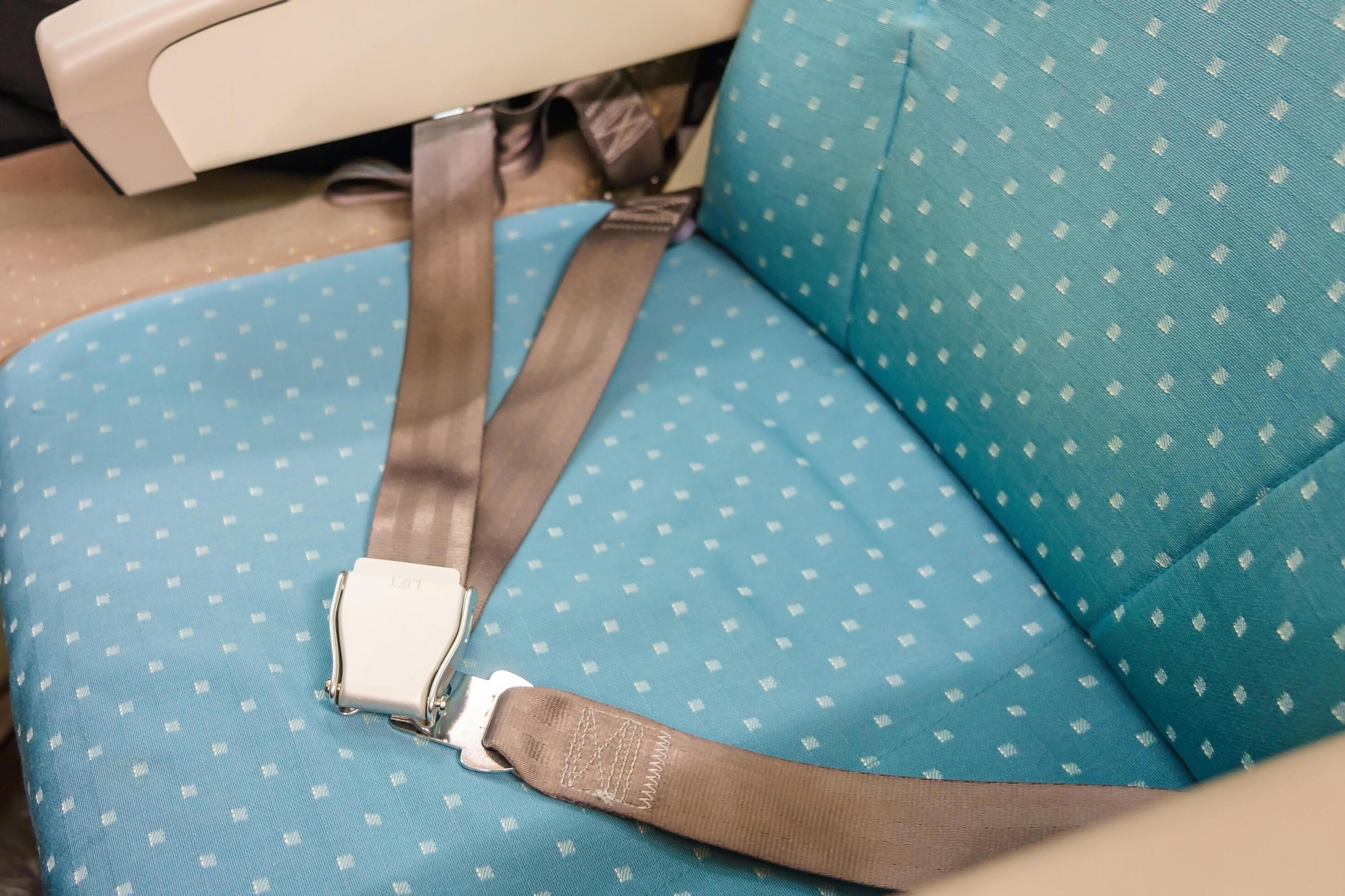 Seat belt on passenger seat in commercial airplane 1996200 Stock Photo at Vecteezy
