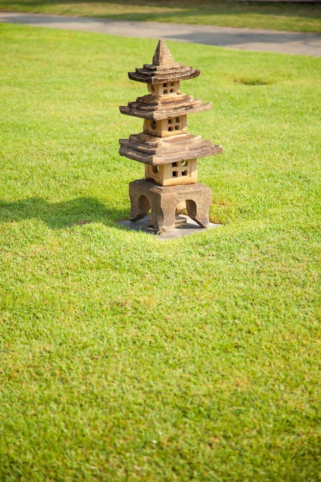 Stone lantern on the grass photo