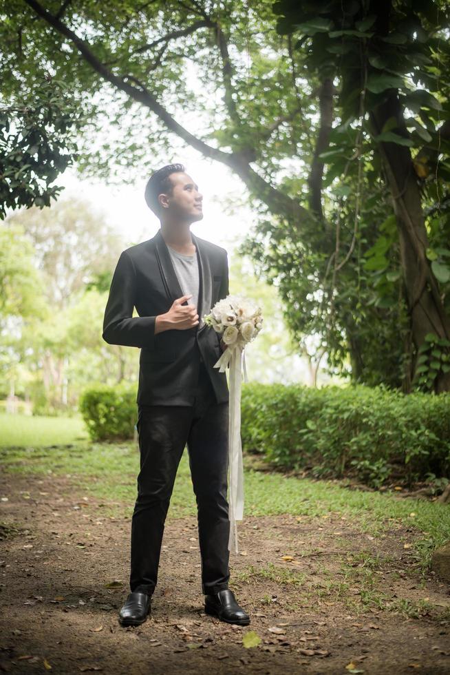 Beautiful bouquet in the hands of the groom for bride photo