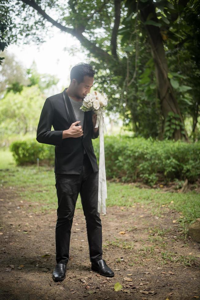 Beautiful bouquet in the hands of the groom for bride photo